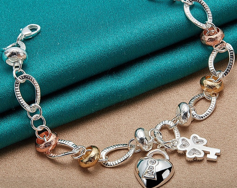 Charming Silver Bracelet with Heart Lock, Clover, and Flower Accents for Women [Low stock]